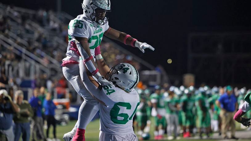 Badin's Drew Vocke lifts his teammate Lem Grayson into the air after he scored a touchdown during Friday's game at CJ. BILL LACKEY/STAFF