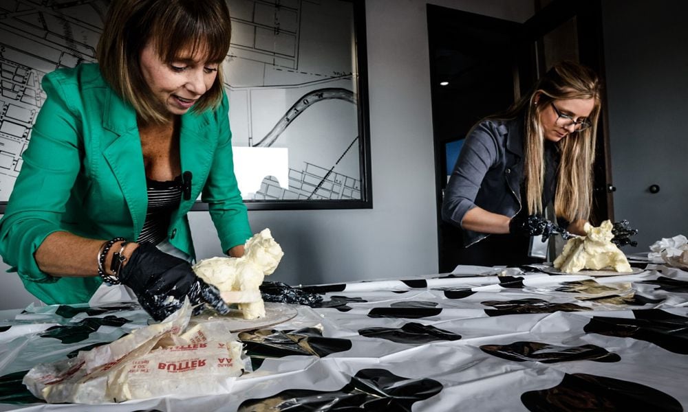 Food & Dining Reporter Natalie Jones (right) and Publisher Suzanne Klopfenstein (left) attempted to make their own butter cow in honor of the display at the Ohio State Fair. JIM NOELKER/STAFF