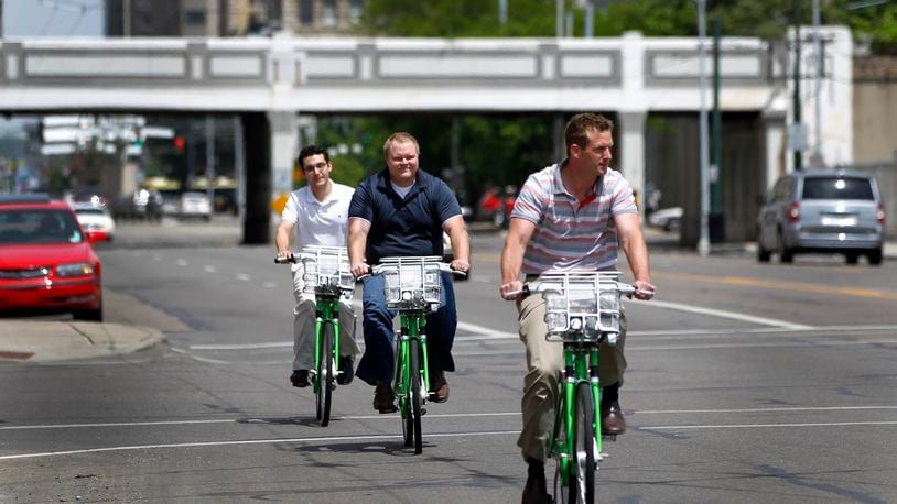 Eric Wright, Chris Lialios and Stetson Blake (front to rear) checked out bicycles from the Link Dayton Bike Share in downtown Dayton to ride from their office to Brown Street to have lunch. LISA POWELL / STAFF 2015 FILE PHOTO