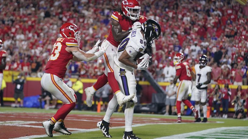 Baltimore Ravens tight end Isaiah Likely, left, catches a pass with his toe out of bounds as Kansas City Chiefs linebacker Nick Bolton (32) and linebacker Drue Tranquill (23) defend as time time expires in the second half of an NFL football game Thursday, Sept. 5, 2024, in Kansas City, Mo. The Chiefs won 27-20.(AP Photo/Ed Zurga)