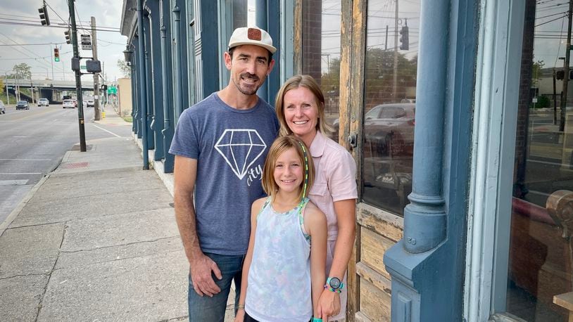 Burgess and Jeanine Gow of 521 LLC have purchased the Dietz Block building on Wayne Avenue in Dayton. Pictured with the couple is their daughter, Kay. NATALIE JONES/STAFF