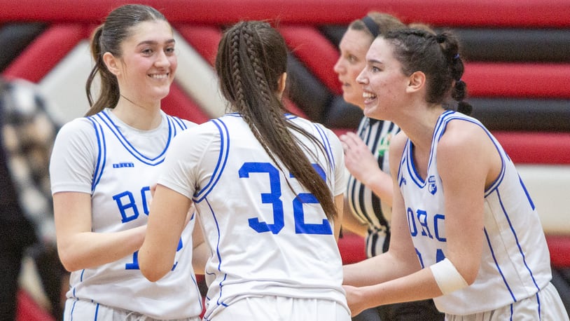 Springboro's Bryn Martin (left), Carly Turman (32) and Chloe Downing celebrate their 71-64 regional semifinal victory over Mason on Wednesday night at Lakota West High School. Jeff Gilbert/CONTRIBUTED