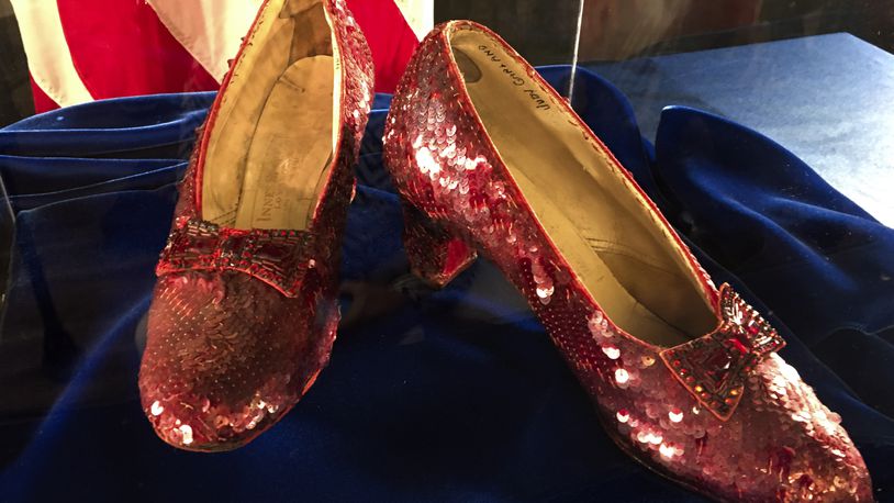 FILE - Ruby slippers once worn by Judy Garland in the "The Wizard of Oz," are displayed at a news conference, Sept. 4, 2018, at the FBI office in Brooklyn Center, Minn. The Minnesota hometown of Judy Garland, the late actress who wore the ruby slippers in “The Wizard of Oz,” will raise funds this weekend to recover the prized footwear after it was stolen from a local museum and then turned over to an auction company. (AP Photo/Jeff Baenen, File)
