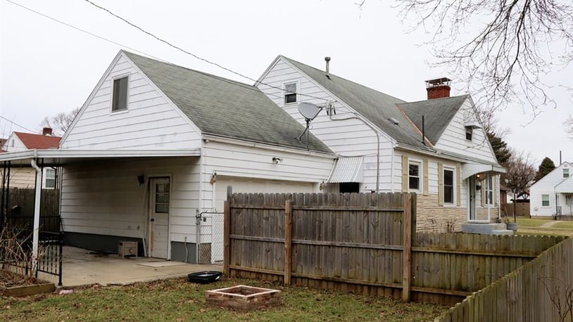 A door from the kitchen leads to the 2-car garage, which has a side service door that opens to the covered patio.