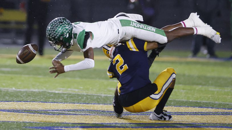 Springfield's Ty Myers forces Northmont's Cahke Cortner to fumble the ball as he tackles him during Friday's game. BILL LACKEY/STAFF