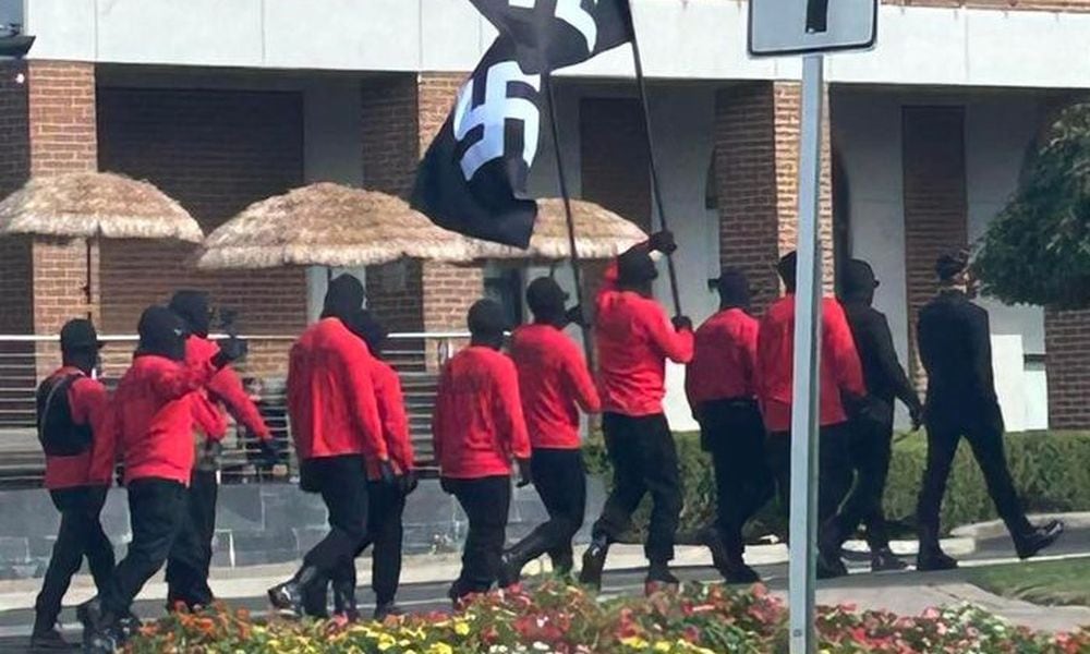 12 people carrying swastika flags and rifles while wearing ski masks walked around downtown Springfield during the Jazz & Blues Fest on Saturday, Aug. 10, 2024. Contributed photo, courtesy Chelsea Shirk Weber.