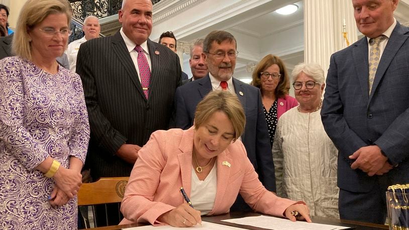 Massachusetts Gov. Maura Healey signs into law a bill that would phase out the use of PFAS, a group of toxic industrial compounds, in firefighters' protective gear, at the Massachusetts Statehouse, Thursday, Aug. 15, 2024, in Boston. The chemical, associated with health problems including several types of cancer, is used in gear to repel water and other substances when fighting a fire. (AP Photo/Steve LeBlanc)