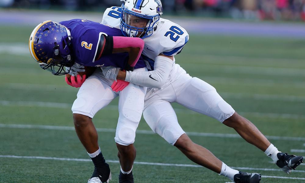 Butler's Tayven Crump is tackled by Xenia's Trimonde Henry after catching a pass. BILL LACKEY/STAFF