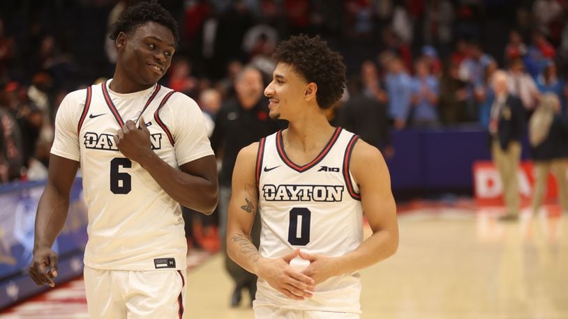 Dayton's Enoch Cheeks and Javon Bennett leave the court after a victory against Grambling State on Saturday, Dec. 2, 2023, at UD Arena. David Jablonski/Staff