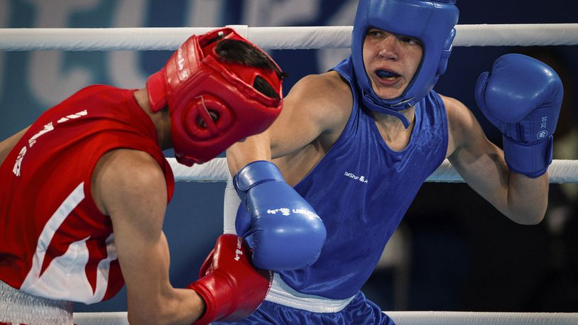 In this photo provided by the International Olympic Committee, Maksym Halinichev of Ukraine, right, competes against Abdumalik Khalokov of Uzbekistan in the Boxing Men's Bantam (56kg) Gold Medal Bout at the Oceania Pavilion of Youth Olympic Park during the Youth Olympic Games in Buenos Aires, Argentina, Thursday, Oct. 18, 2018. As one of Ukraine’s most promising boxing prospects, Halinichev could have been shielded from the war. (Jonathan Nackstrand/IOC via AP)