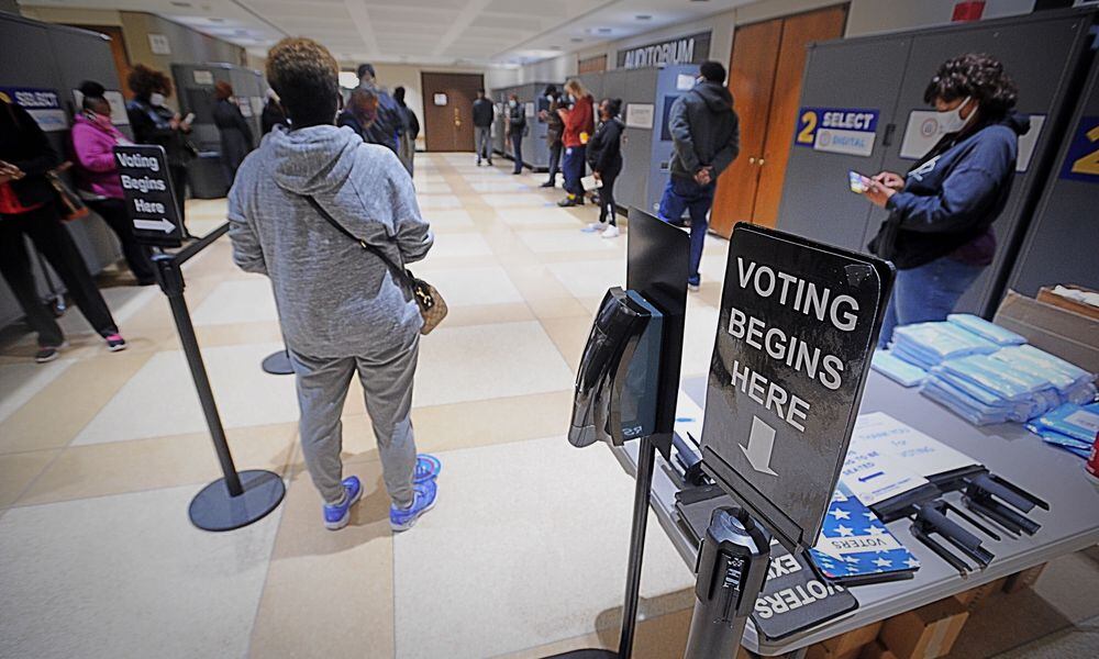 Long lines greeted voters at the Montgomery County Board of Elections on Tuesday, Oct. 6, 2020, as early voting began for the November general election. Registered voters can cast their ballot at the board of elections located at 451 W. Third St. in Dayton. MARSHALL GORBY/STAFF