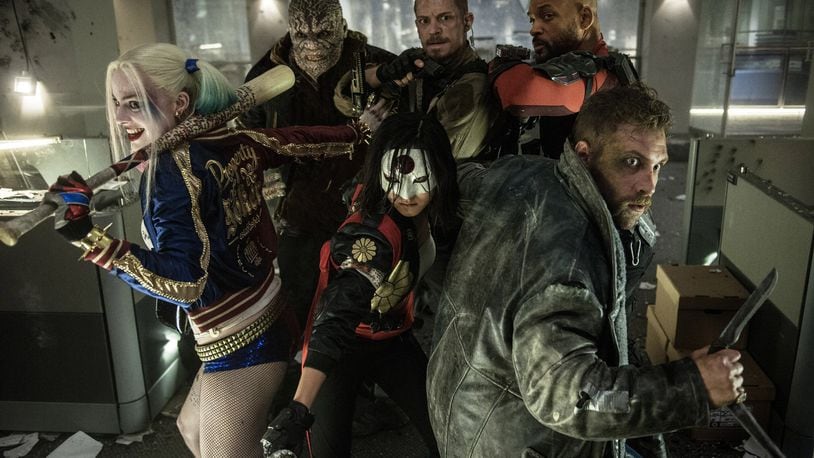 This image released by Warner Bros. Entertainment shows, from left, Margot Robbie, Adewale Akinnuoye-Agbaje, Karen Fukuhara, foreground center, Joel Kinnaman, Will Smith and Jao Courtney, foreground right, in a scene from “Suicide Squad,” opening nationwide on Aug. 5. (Clay Enos/Warner Bros. Entertainment via AP)