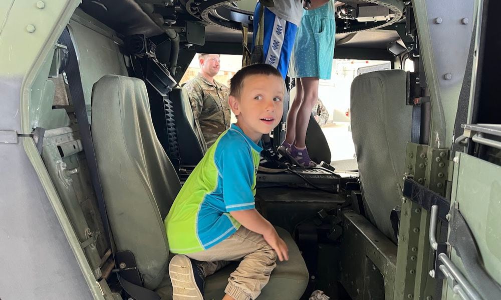 Emmett Cuccia, 4, could be seen climbing aboard a Humvee in a Wright-Patterson Air Force Base hangar at Operation K.U.D.O.S Friday morning. The event was meant to give children insights into life in military deployment for their active-duty parents. THOMAS GNAU/STAFF