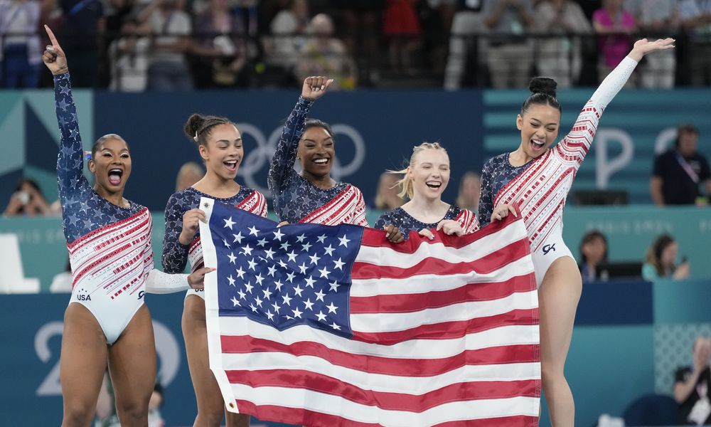 Members of Team USA celebrate after winning the gold medal in the women's artistic gymnastics team finals round at Bercy Arena at the 2024 Summer Olympics, Tuesday, July 30, 2024, in Paris, France. (AP Photo/Natacha Pisarenko)