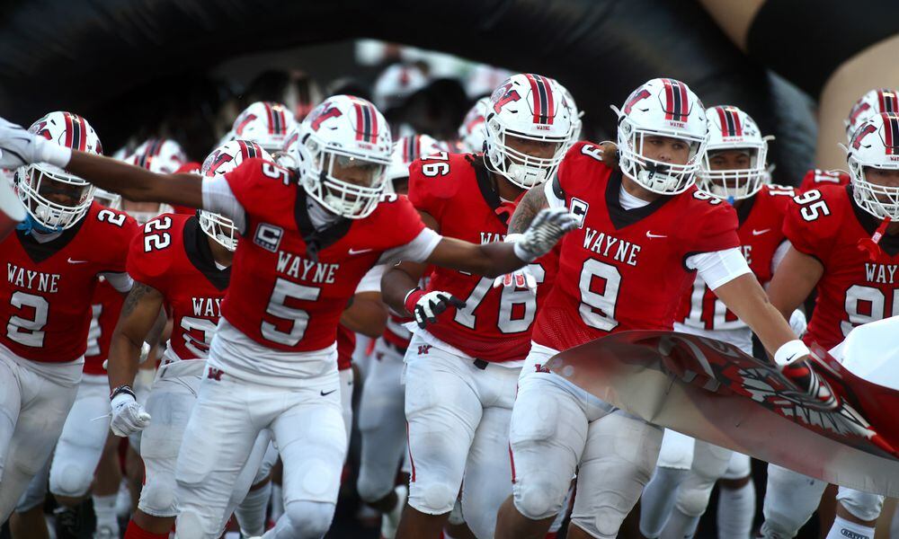 Wayne takes the field against Pickerington Central on Friday, Aug. 30, 2024, at Heidkamp Stadium in Huber Heights. David Jablonski/Staff