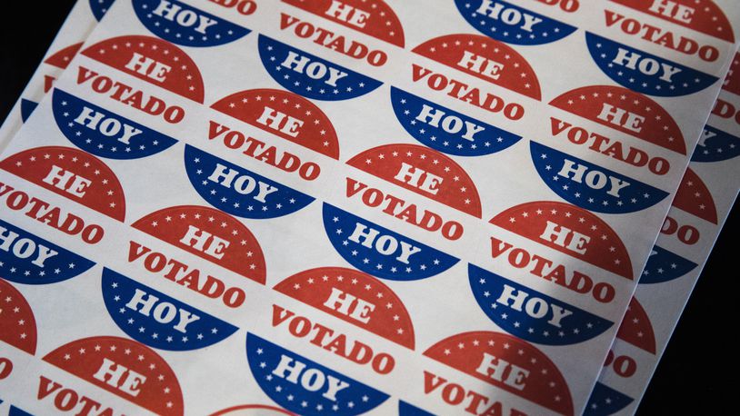 FILE - Spanish language voting stickers which read "He Votado Hoy" ("I Voted Today") are offered at a polling place in Philadelphia, May 21, 2019. (AP Photo/Matt Rourke, File)