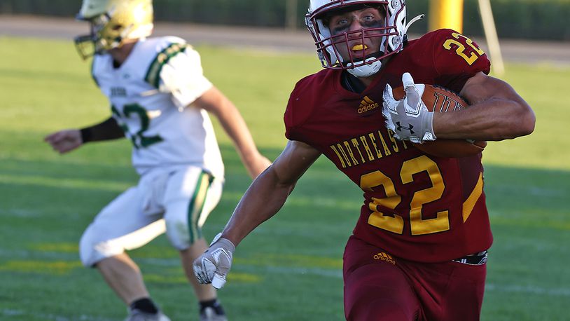 Northeastern's Garrett Chadwell carries the ball for a first down against Catholic Central during Friday's game. BILL LACKEY/STAFF