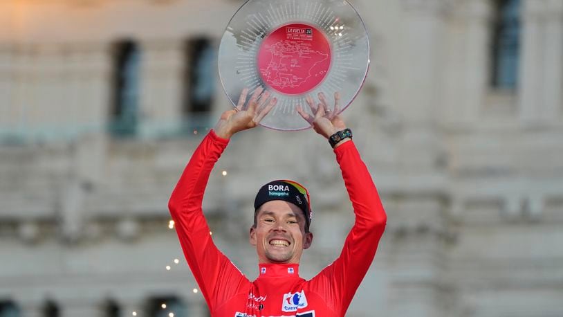 Primoz Roglic of Slovenia lifts the trophy after winning La Vuelta cycling race during the last stage in Madrid, Spain, Sunday, Sept. 8, 2024. (AP Photo/Paul White)