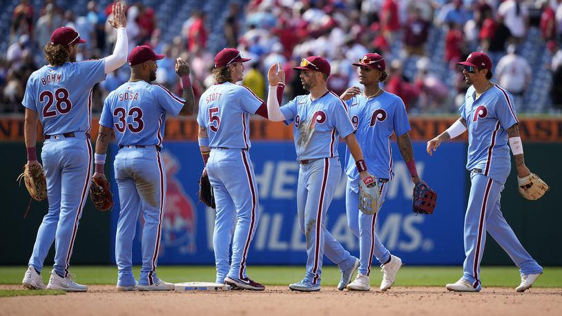 Philadelphia Phillies' players celebrate after winning a baseball game against the Texas Rangers, Thursday, May 23, 2024, in Philadelphia. (AP Photo/Matt Slocum)