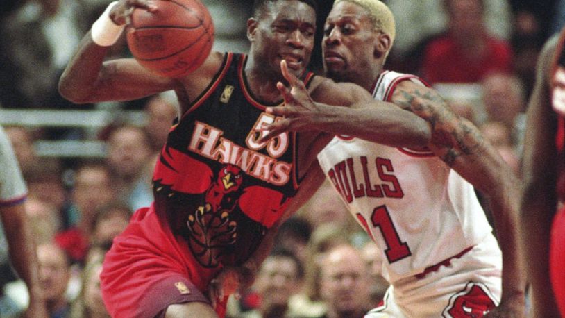 FILE - The Atlanta Hawks' Dikembe Mutombo, left, drives to the hoop against the Chicago Bulls' Dennis Rodman during the second quarter of their playoff game Thursday, May 8, 1997, in Chicago. (AP Photo/Michael S. Green, File)