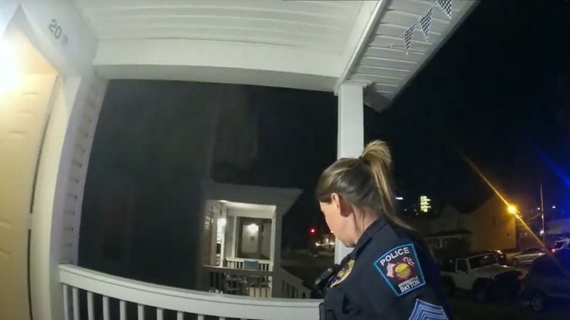 Officers on body cameras wait outside of a University of Dayton rowhouse for a student they believed was screaming obscenities at them while they were working. Courtesy of UD