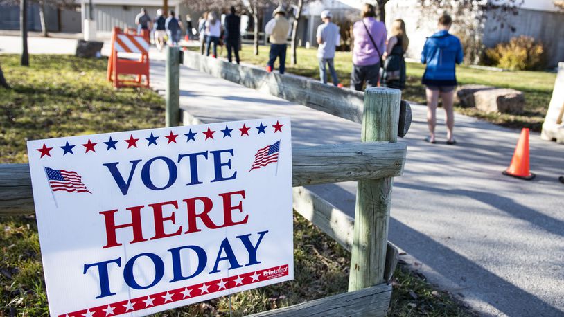 FILE - Patrons of the Gallatin County Fairgrounds wait in line to cast their ballots in Bozeman, Mont., Nov. 3, 2020. (AP Photo/Tommy Martino, File)