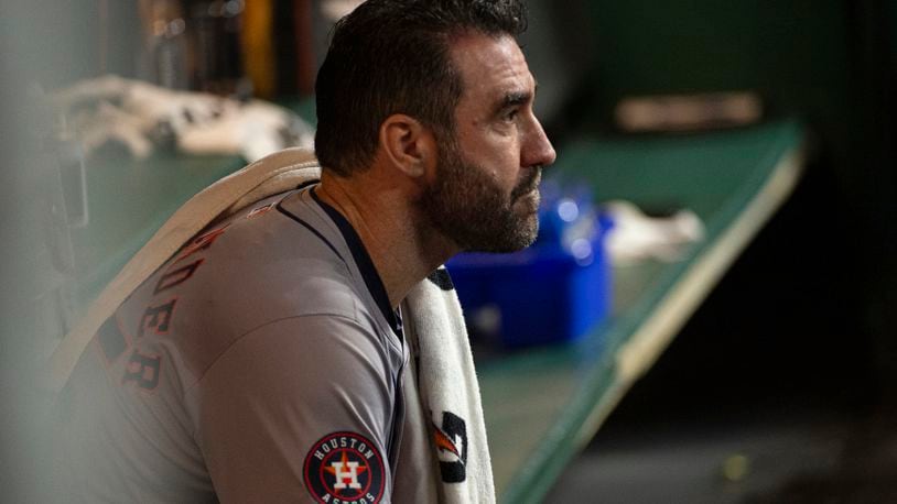 Houston Astros starting pitcher Justin Verlander sits in the dugout during the fifth inning of a baseball game against the Cleveland Guardians in Cleveland, Saturday, Sept. 28, 2024. (AP Photo/Phil Long)