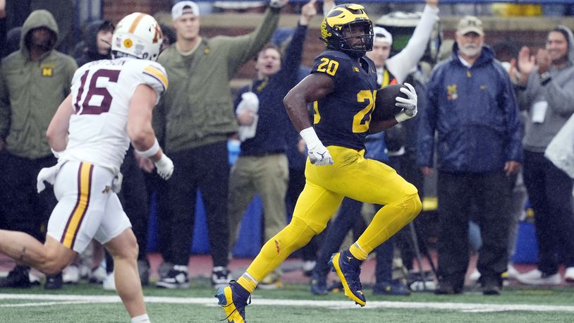 Michigan running back Kalel Mullings (20) pulls away from Minnesota Golden defensive back Coleman Bryson (16) for a 27-yard rushing touchdown during the first half of an NCAA college football game, Saturday, Sept. 28, 2024, in Ann Arbor, Mich. (AP Photo/Carlos Osorio)