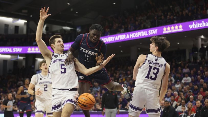 Dayton's Enoch Cheeks loses the ball as he drives to the basket against Northwestern on Friday, Nov. 10, 2023, at Welsh-Ryan Arena in Evanston, Ill. David Jablonski/Staff