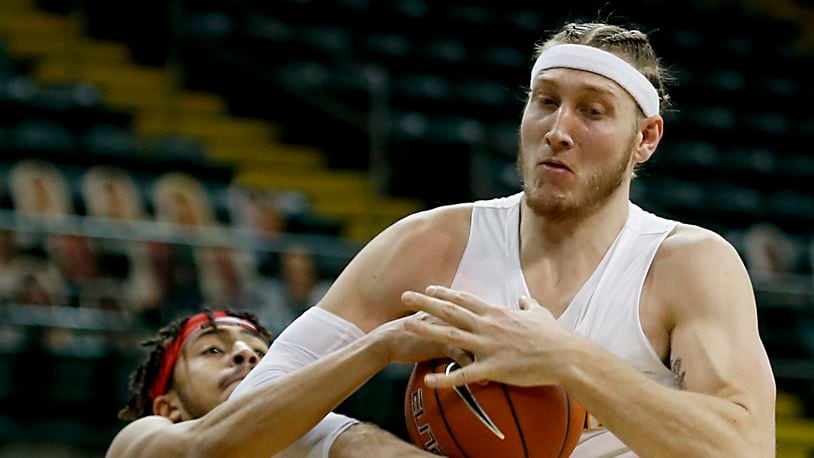 Wright State center Loudon Love and Youngstown State forward Michael Akuchie battle for a rebound under the Wright State basket during a Horizon League game at the Nutter Center in Fairborn Jan. 9, 2021. Wright State won 93-55. Contributed photo by E.L. Hubbard