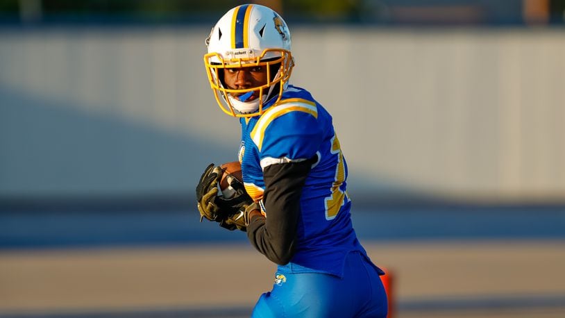 Cutline 2: Ponitz High School's Jahfunte Jackson looks back as he runs into the end zone during their game against Carroll on Thursday, Aug. 22 at Dayton Welcome Stadium. Michael Cooper/CONTRIBUTED