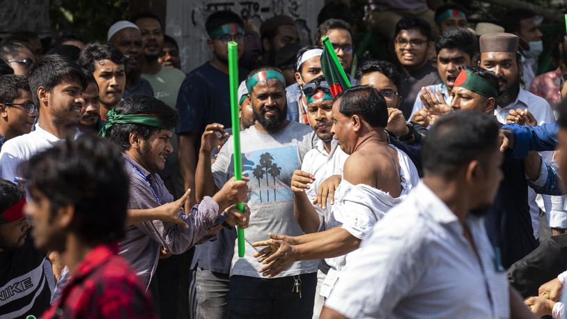 Student protesters rough up a supporter of the ousted Prime Minister Sheikh Hasina's Awami League party suspecting him of paying respect to her father Sheikh Mujibur Rahman on his death anniversary outside his residence in Dhaka, Bangladesh, Thursday, August 15, 2024. (AP Photo/Rajib Dhar)