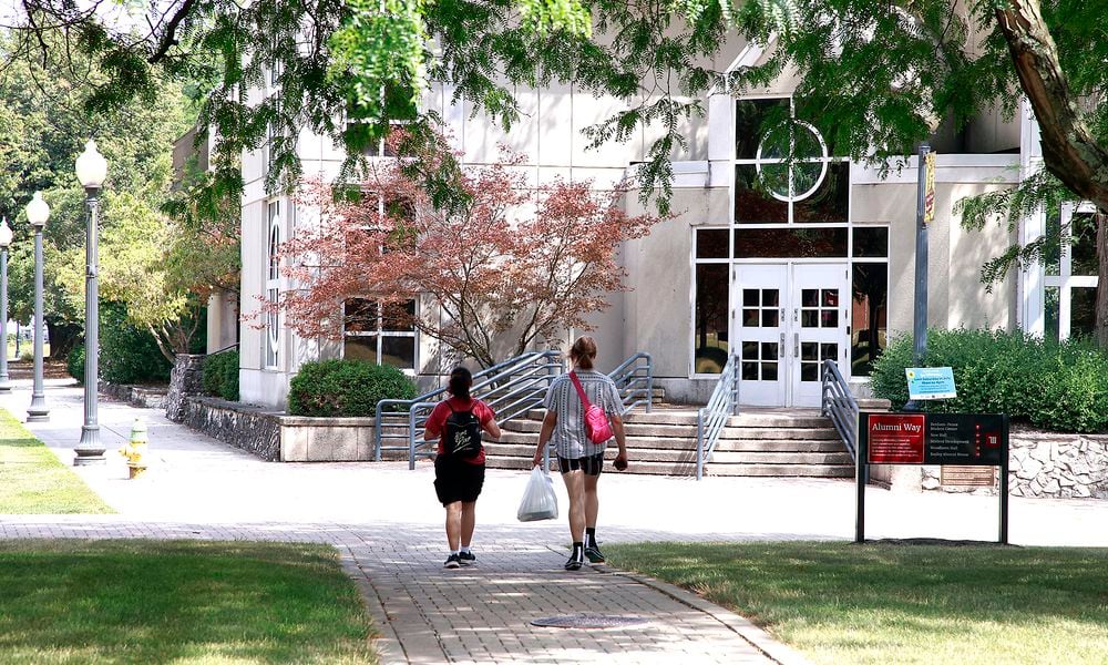 Two students walk across the campus of Wittenberg University Thursday, August 1, 2024. BILL LACKEY/STAFF