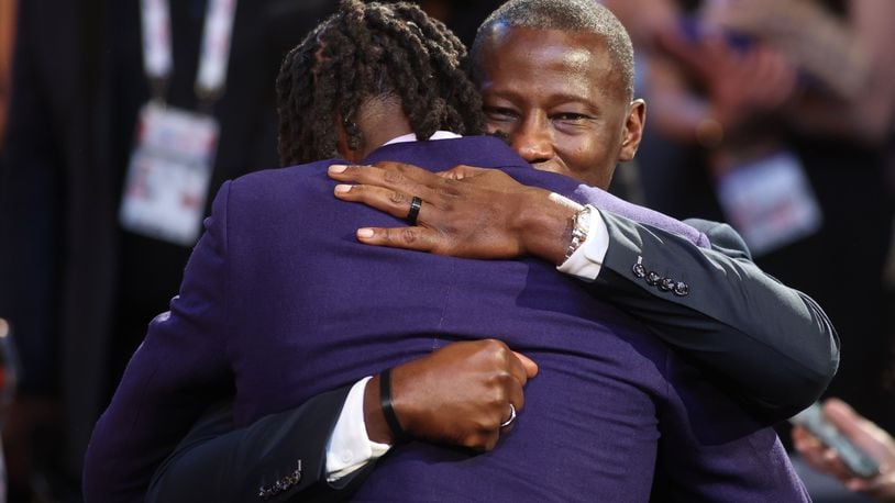 DaRon Holmes hugs Dayton's Anthony Grant after being selected with the No. 22 pick in the NBA Draft on Wednesday, June 26, 2024, at the Barclays Center in Brooklyn, N.Y. David Jablonski/Staff