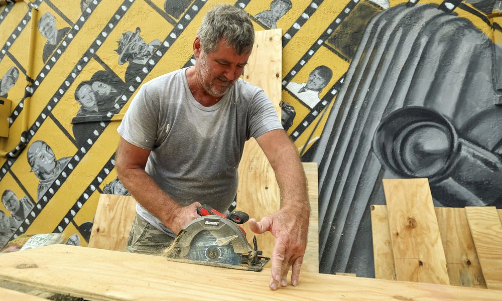 Jay McCoy puts up plywood in preparation for Hurricane Milton on Monday, Oct. 7, 2024, in New Port Richey, Fla. (AP Photo/Mike Carlson)