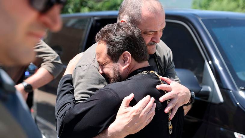 In this photo released by The Telegram Channel of the administration of the head of Dagestan Republic of Russia on Monday, June 24, 2024, the head of Dagestan Republic Sergei Melikov, center, embraces and comforts a priest as he visits the Orthodox Church of the Intercession of the Blessed Virgin Mary in Derbent after a counter-terrorist operation in republic of Dagestan, Russia. Multiple police officers and several civilians, including an Orthodox priest, were killed by armed militants in Russia's southern republic of Dagestan on Sunday, its governor Sergei Melikov said in a video statement early Monday. (The Telegram Channel of the administration of the head of Dagestan Republic of Russia via AP)