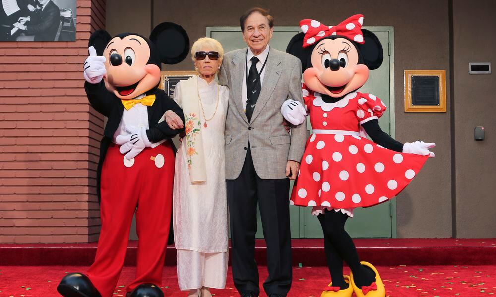 FILE - Mickey Mouse, from left, Elizabeth Gluck, Richard M. Sherman and Minnie Mouse pose for a photo at the ceremony honoring the Sherman Brothers with the rename of Disney Studios Soundstage A at the world premiere of Disney's 