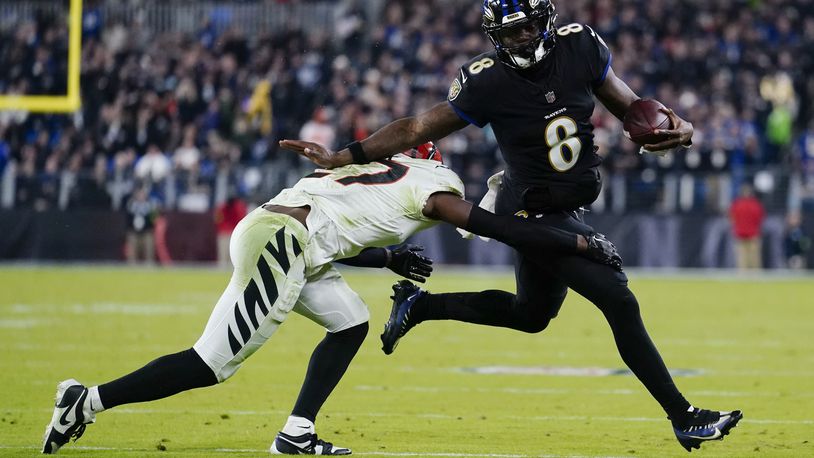 Cincinnati Bengals safety Jordan Battle (27) tackles Baltimore Ravens quarterback Lamar Jackson (8) in the second half of an NFL football game in Baltimore, Thursday, Nov. 16, 2023. (AP Photo/Matt Rourke)