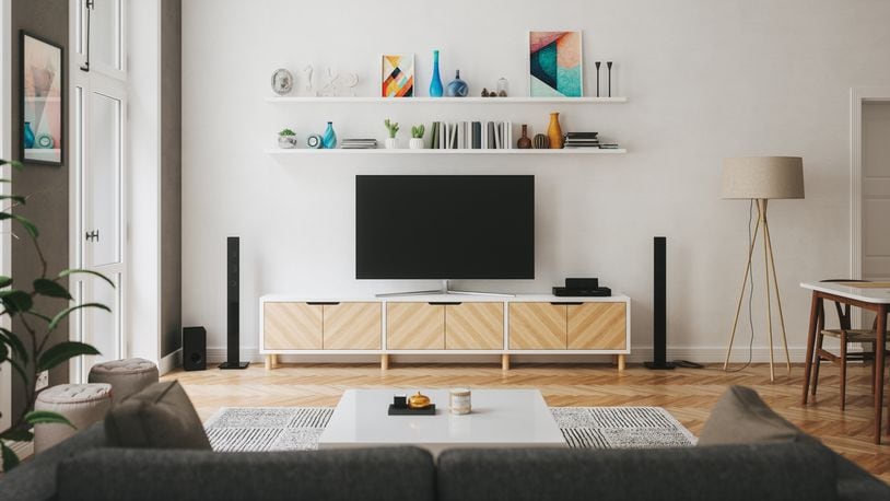 Are you a sports fan who subscribes to Disney+? You may soon be able to receive live sports from ESPN as a part of the video streaming subscription. Pictured is a living room with home entertainment center. IMAGINIMA/ISTOCK