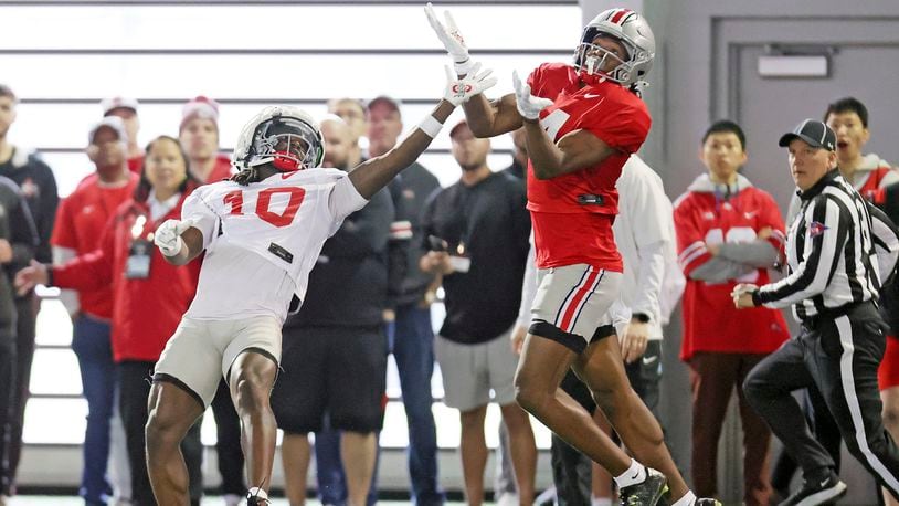 Ohio State University pass-catching prodigy Jeremiah Smith, right, and corner back Jordan Hancock battle for a pass during the NCAA college football team's fan appreciation day workout in Columbus, Ohio, March 29, 2024. (John Kuntz/Cleveland.com via AP)/Cleveland.com via AP)