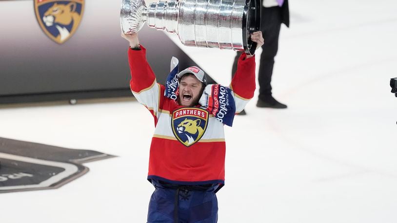 FILE - Florida Panthers center Aleksander Barkov (16) lifts the Stanley Cup trophy after Game 7 of the NHL hockey Stanley Cup Final, on June 24, 2024, in Sunrise, Fla. (AP Photo/Rebecca Blackwell, File)