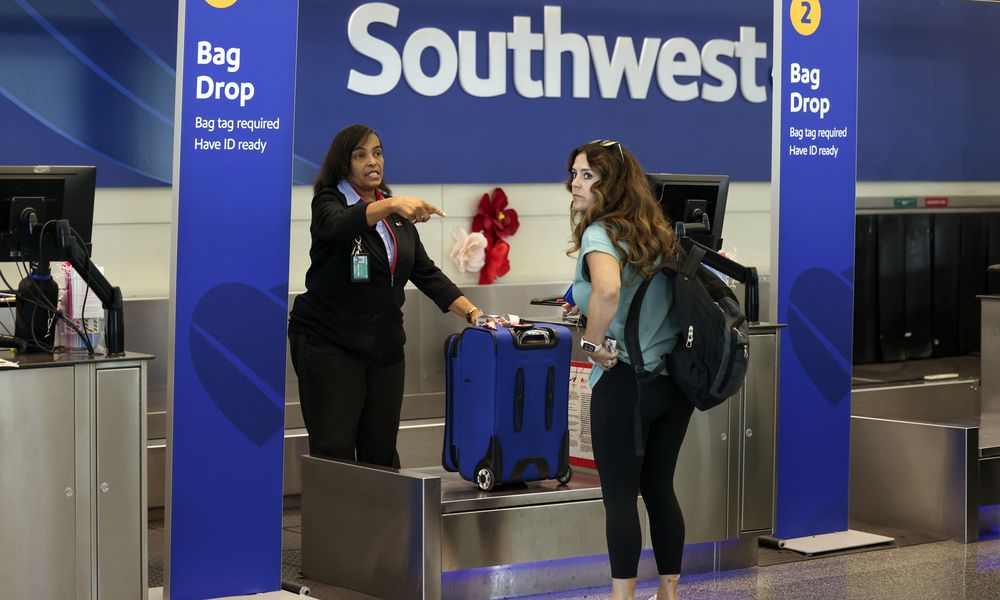 A passenger checks in for her Southwest Airlines flight at Midway International Airport in Chicago, Thursday, July 25, 2024. Southwest Airlines plans to drop the open-boarding system it has used for more than 50 years and will start assigning passengers to seats, just like all the other big airlines. (AP Photo/Teresa Crawford)