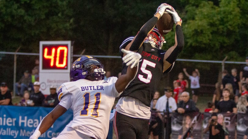 Tippecanoe's Dylan Herndon catches a pass over Vandalia Butler's Davon Smith during the first half of Thursday night's game won by Tipp 25-7. Jeff Gilbert/CONTRIBUTED