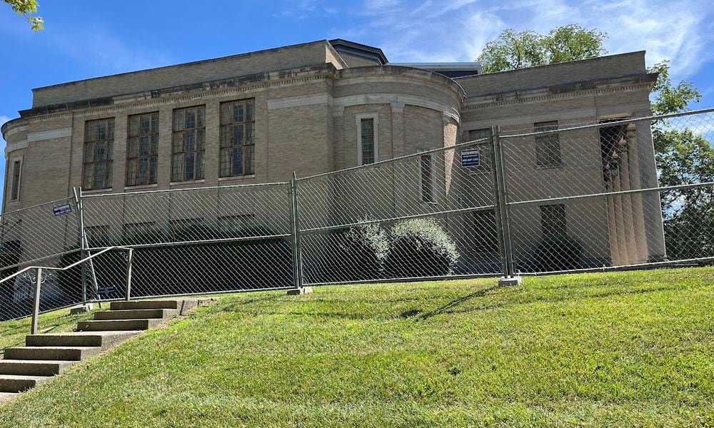 The former church was being fenced off at 105 Sawmill Road in south Dayton Tuesday. The city of Dayton has issued a commercial wrecking permit for the site. THOMAS GNAU/STAFF