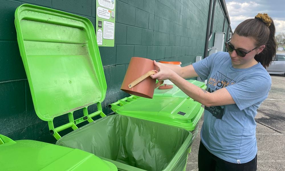 Waste-Free Dayton has teamed up with 2nd Street Market to offer a free, community compost station located on the backside of the market near Webster Street. Pictured is Natalie Warrick, founder and co-executive director of Waste-Free Dayton. NATALIE JONES/STAFF