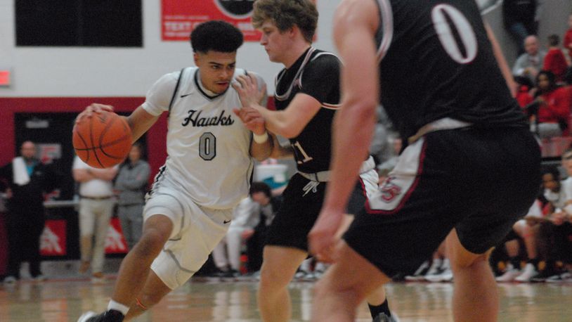 Lakota East's Trey Perry (0) is guarded by La Salle's Cohen Kreidler on Friday night. Chris Vogt/CONTRIBUTED