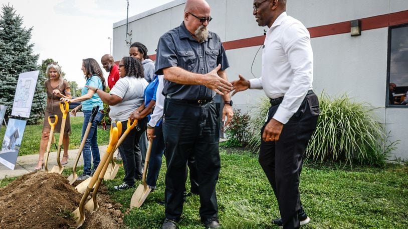 Director of Transportation Fleet Maintenance for Dayton Public Schools David Beard, left and Interim Dayton Public Schools superintendent David Lawrence celebrate after the groundbreaking of the new Jackson Center on James H. McGee Blvd. Friday August 11, 2023. JIM NOELKER/STAFF