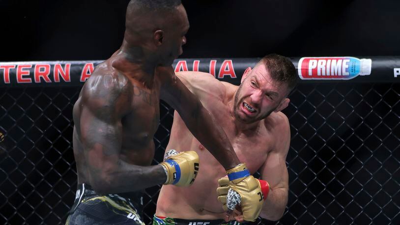 Dricus du Plessis, right, of South Africa and Israel Adesanya of Nigeria fight during their Middleweight title bout at UFC 305 at RAC Arena in Perth, Sunday, Aug. 18, 2024. (Richard Wainwright/AAP Image via AP)