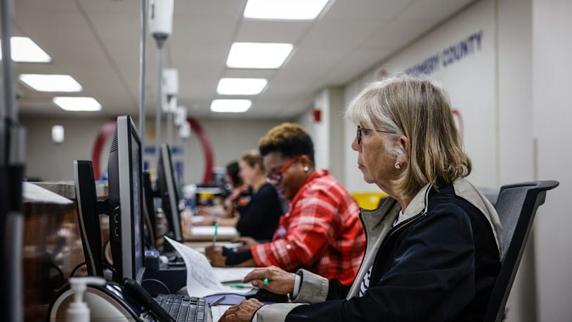 Montgomery County Board of Election workers check voter registration data on Friday, Sept. 13, 2024. JIM NOELKER/STAFF