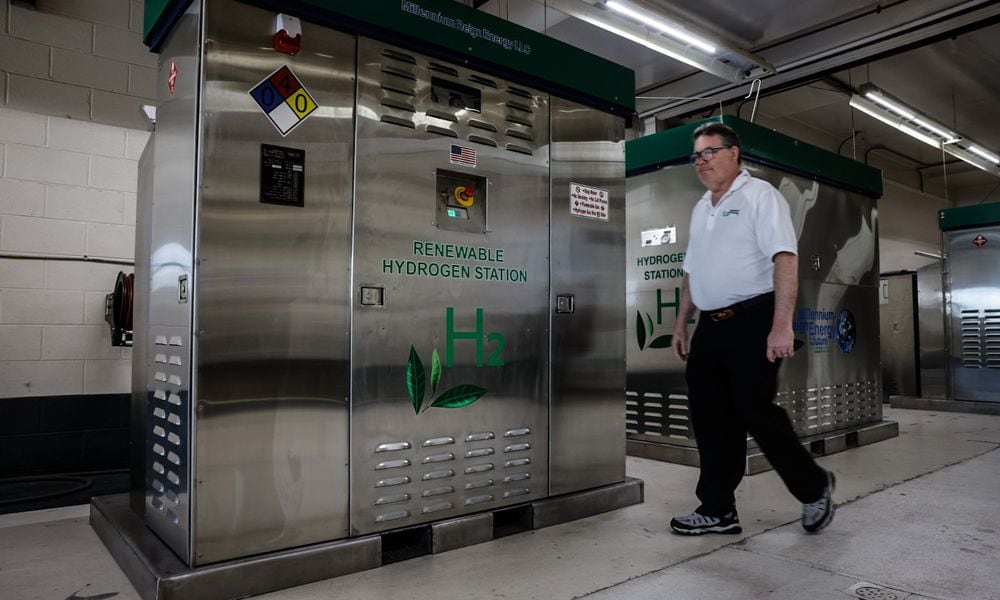 Founder and CEO of Millennium Reign Energy walks by a Renewable Hydrogen Station that is company builds on North Main Street in Dayton Friday July 19, 2024. JIM NOELKER/STAFF